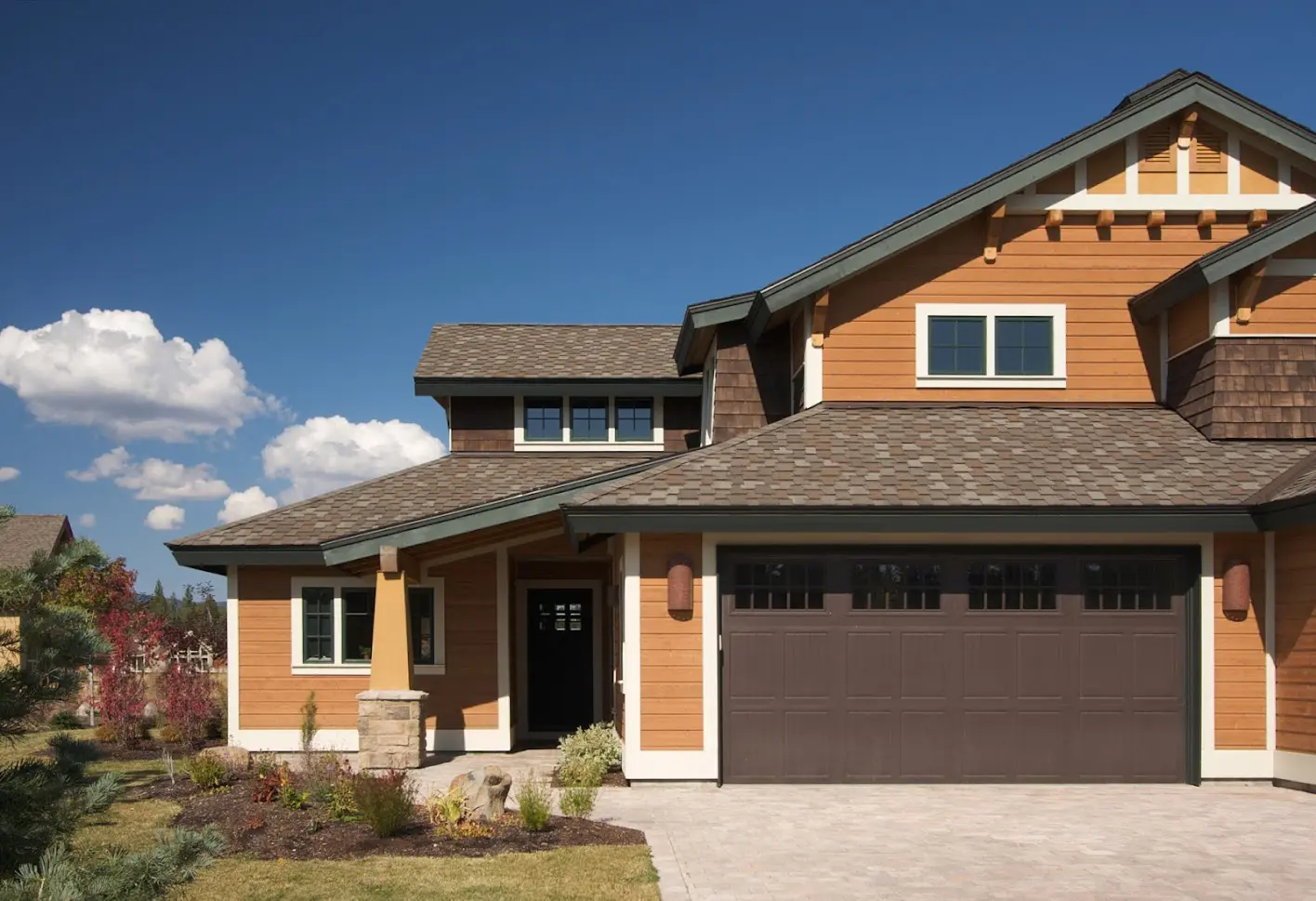 A house with brown garage door and white trim.