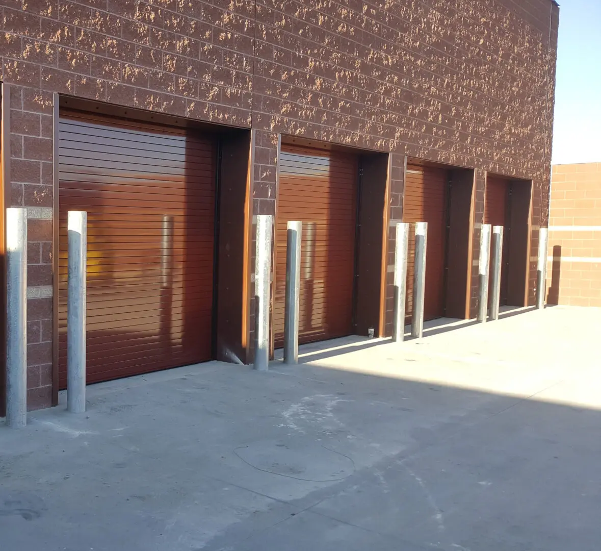 A row of garage doors in front of a building.