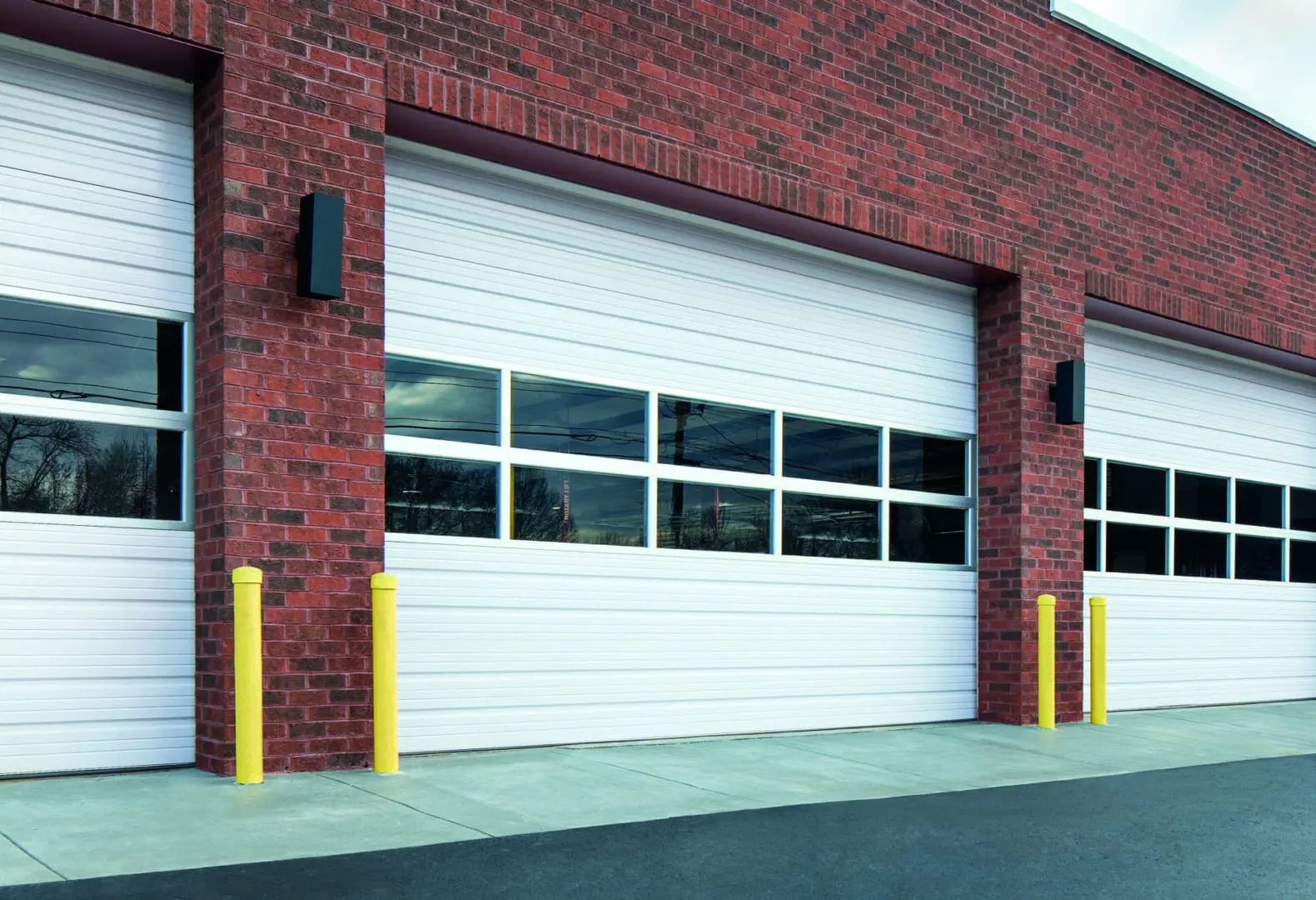 A fire station with a red brick wall and yellow trim.