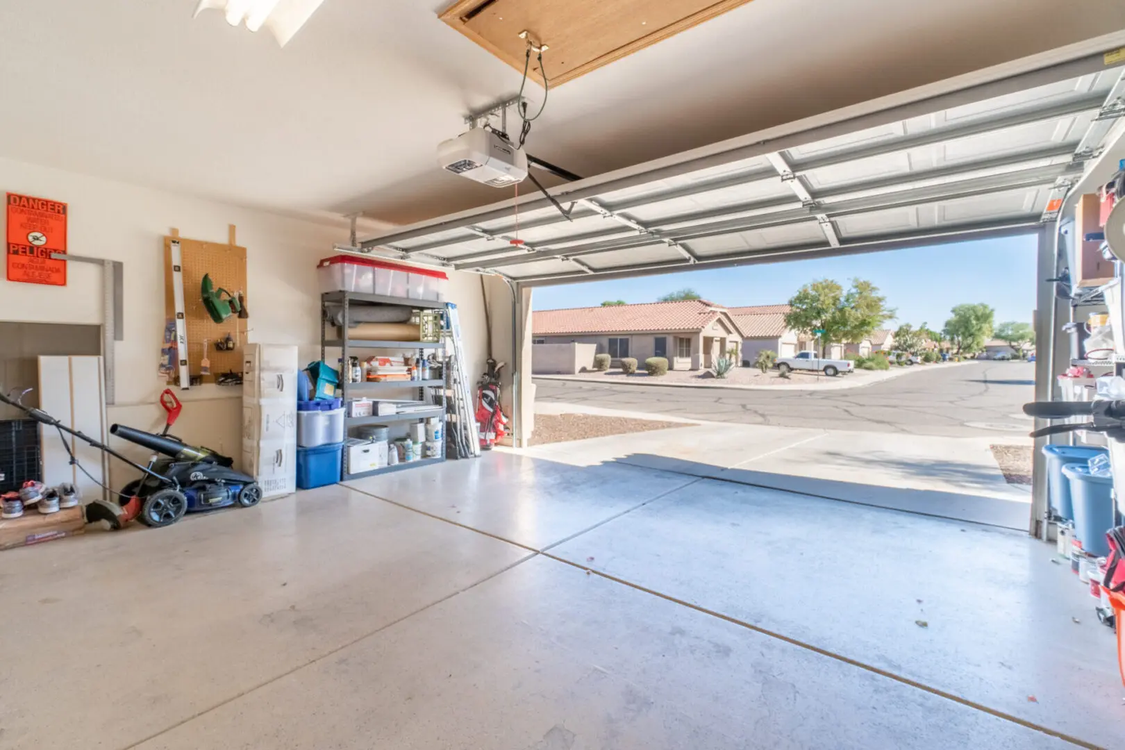 A garage with two cars parked in it.