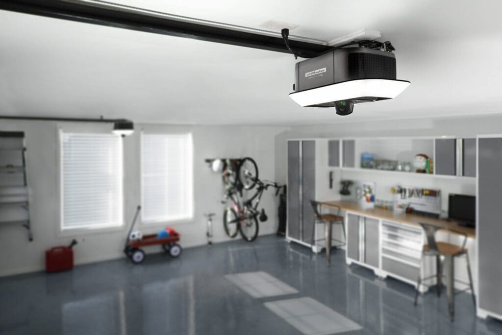 A garage with two bikes hanging from the ceiling.