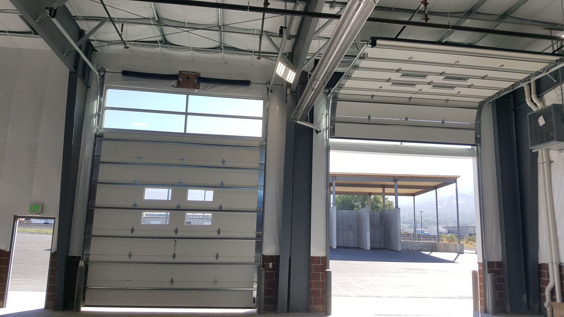 Beacon Garage Doors commercial garage door repair in Bountiful, Utah, with multiple doors open.