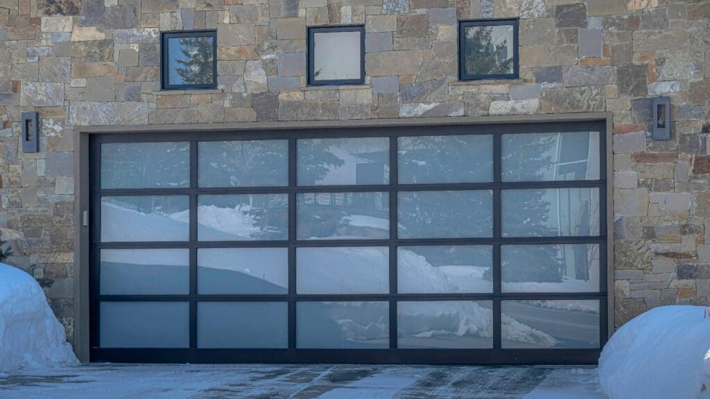 A large garage door with windows on the side of it.