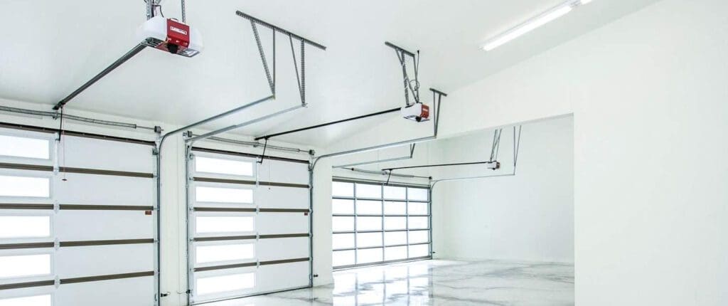 A garage with two doors and three lifts.