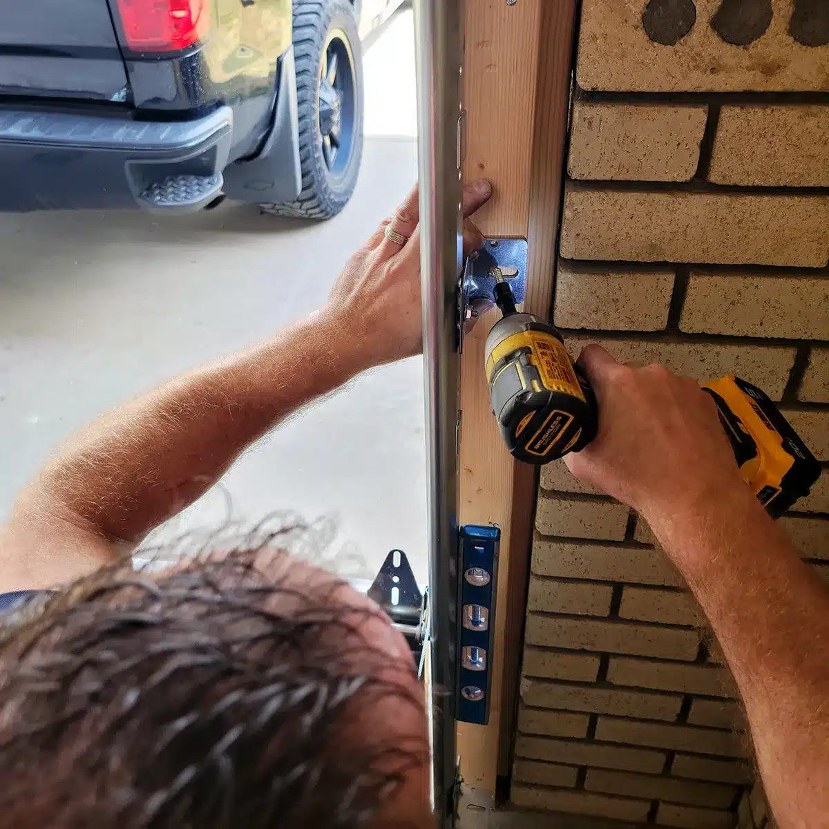 Garage door repair technician fixing torsion spring in Riverdale, Utah – Beacon Garage Doors
